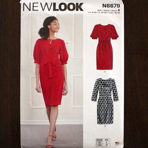 May include: A New Look sewing pattern, N6679, featuring a red dress with puff sleeves and a tie waist. The pattern also includes a dress with a black and white floral print. The size range is U.S. 6-18.