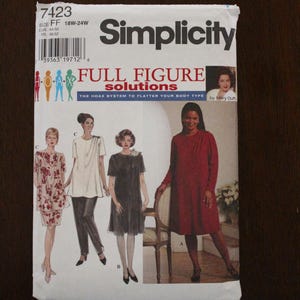 May include: Simplicity sewing pattern 7423 for full figure solutions. The pattern features illustrations of dresses and tops. The size range is 18W-24W. The cover includes the text "Full Figure Solutions" and "The Hoax System to Flatter Your Body Type."