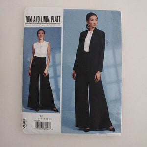 May include: A Vogue Patterns sewing pattern by Tom and Linda Platt, featuring a woman in a black suit with wide-leg pants and a white top. The pattern number is V1620, size E5 (14-16-18-20-22).