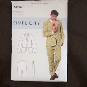 May include: A Simplicity sewing pattern for a suit, featuring a jacket, pants, and tie. The pattern is for sizes US 34-42, Euro 44-52, and French 44-52. The pattern includes a line drawing of the suit and a photo of a model wearing the suit.