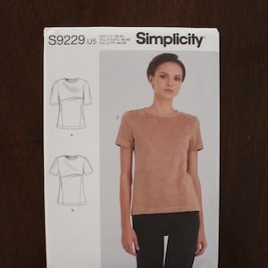 May include: Simplicity sewing pattern number S9229 US 5 for sizes 16-24, 40-50, 44-52. The pattern includes instructions and diagrams for making a t-shirt with short sleeves.