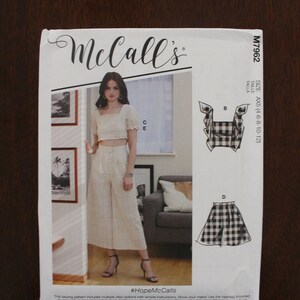 May include: A sewing pattern for a women's top and pants set. The pattern includes multiple views and simple instructions. The pattern is for sizes 4-6-8-10-12. The pattern is from McCall's and is called #HopeMcCalls.