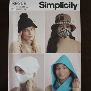 May include: Simplicity sewing pattern S9368 featuring four hat and face covering designs. The designs include a black beanie, a plaid bucket hat with matching face mask, a white beanie with a face mask, and a blue hood.
