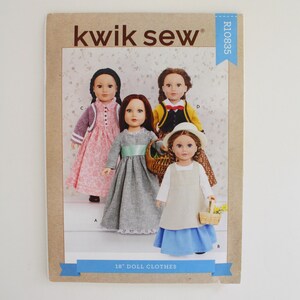 May include: A Kwik Sew sewing pattern envelope for 18 inch doll clothes, labeled R10835. The cover features four dolls wearing various outfits, including a pink floral dress, a grey dress with a green sash, a yellow jacket, and a blue skirt with a white apron.