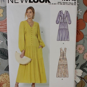 May include: New Look sewing pattern N6718 for a V-neck dress with long sleeves and a tiered skirt. The envelope displays a yellow dress with buttons and two illustrations showing variations A and B in sizes U.S. 8-20, FR. 36-48, and EURO. 34-46.