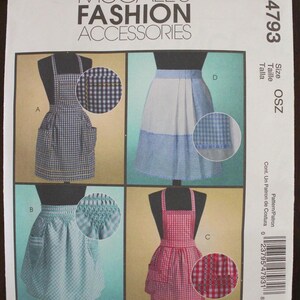 May include: McCall's Fashion Accessories pattern featuring four apron designs. The aprons are displayed in blue, white, and red gingham patterns. The Retro collection is featured on the bottom of the pattern. The pattern number is M4793.