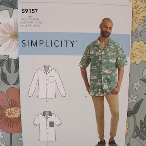 May include: Simplicity sewing pattern S9157 for a button-down shirt with a camp collar and chest pocket. The envelope displays technical line drawings for long and short sleeve versions, alongside a photograph of a green patterned shirt.