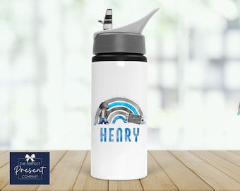 May include: White water bottle with a blue and gray rainbow design, a cartoon figure, and a video game controller. The name "HENRY" is printed below the design.