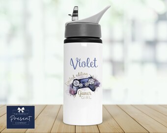 May include: White water bottle with a gray lid and a purple and blue design of a video game controller with flowers and the text "Violet limited edition gamer girl".