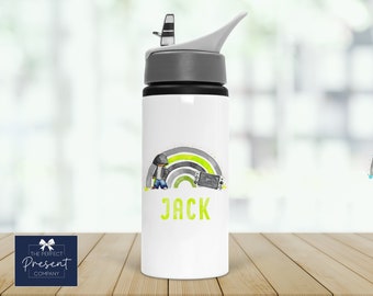 May include: A white water bottle with a gray lid and a black base. The bottle has a green and gray rainbow design with a cartoon figure and a video game controller. The name "JACK" is printed in black below the design.