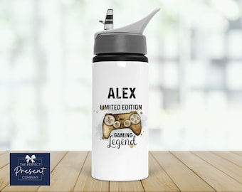 May include: White water bottle with a black lid and a gray flip top. The bottle has a black and brown graphic of a video game controller with the text "Alex Limited Edition Gaming Legend".