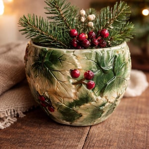 May include: A set of three ceramic mugs with a speckled, matte finish. Each mug features a different color: light blue, cream, and gray. The mugs have a simple, modern design with a rounded shape and a comfortable handle.