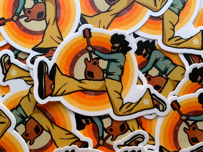 May include: A retro-style sticker featuring a cartoon illustration of a person with an afro, wearing bell-bottom pants and playing a guitar. The person is jumping in the air, and the background is a colorful, concentric circle design.
