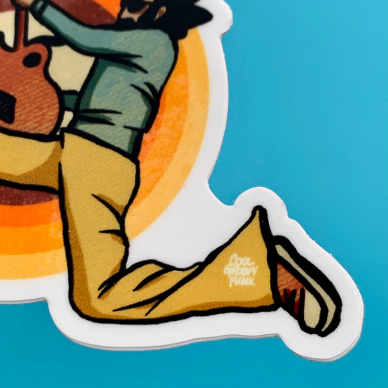 May include: A sticker of a cartoon person playing a guitar, wearing a blue shirt, brown pants, and brown shoes. The person is in a jumping pose. The background is a yellow and orange circle. The sticker has the text "Cool Groovy Funk" on it.
