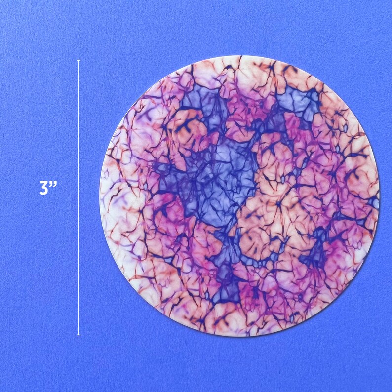 May include: A 3-inch round paper coaster with a marbled design in shades of pink, purple, and white.