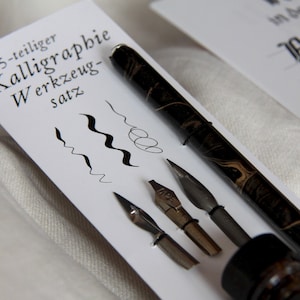 Calligraphy starter set with three nibs, pen holder, ink and book with writing instructions