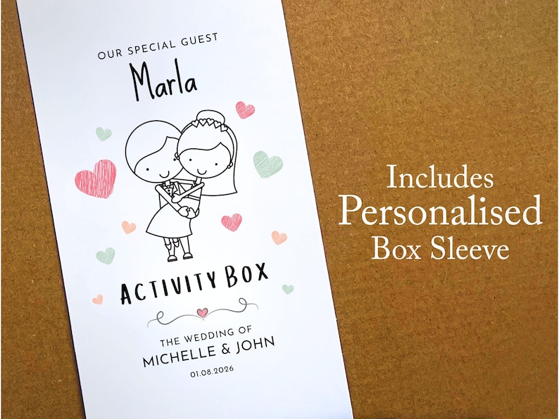 May include: A white rectangular box sleeve featuring a black line drawing of a couple embracing, surrounded by small pink and green hearts. Text reads: OUR SPECIAL GUEST Marla, ACTIVITY BOX, THE WEDDING OF MICHELLE & JOHN, and 01.08.2026.