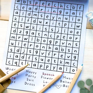 May include: A word search puzzle printed on white paper with a grid of black letters. The words speech and ring are circled in red ink. Below the grid, a list of words includes Wedding, Party, Suit, Dress, Speech, Flower, and Music. Two wooden pencils are placed across the bottom of the page.