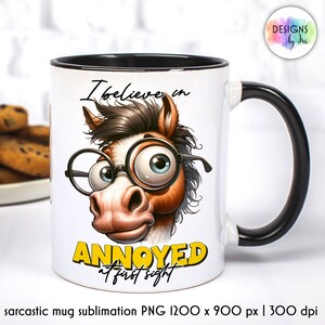 May include: White ceramic mug with a black handle and rim. The mug features a cartoon horse with glasses and the text "I believe in annoyed at first sight".