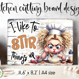 May include: A white cutting board with a distressed wood look. It features a cartoon chef girl with blonde hair and a white chef hat. The text on the board reads "I like to STIR things up". The board measures 11.6 inches by 8.2 inches.