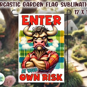 May include: A garden flag with a red, white, and blue plaid background. A cartoon bull with a red bandana is in the center of the flag. The bull is wearing a plaid shirt and has a stern expression. The text "ENTER AT YOUR OWN RISK" is written in red and white letters below the bull.