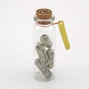 Immoral Fiber - Satirical shredded money pill capsule sculpture from Nemo Gould