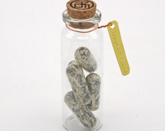Immoral Fiber - Satirical shredded money pill capsule sculpture from Nemo Gould