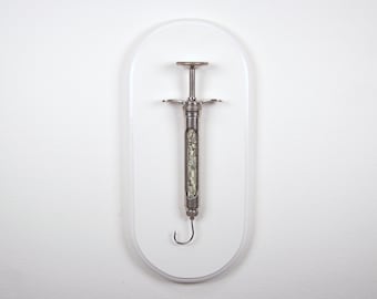 Hooked V4 - Satirical dollar bill/fishook/syringe sculpture from Nemo Gould
