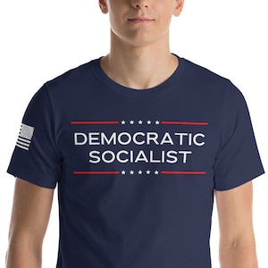 May include: A navy blue t-shirt with the text "DEMOCRATIC SOCIALIST" in white letters. The text is framed by two red lines with five white stars above and below the text.