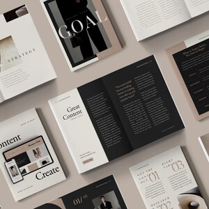 May include: A collection of open books with black and white text and images. The books are on a beige surface. The text on the books includes "Strategy", "Goal", "Great Content", "Get the Content Out", "Right Targets", and "Catch Their Eyes".