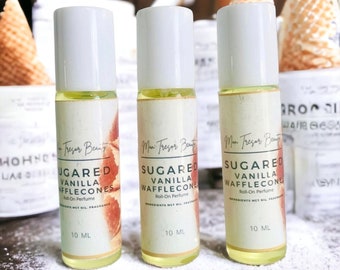 May include: Three 10 ml roll-on perfume bottles with white caps and labels. The labels are cream colored with brown text that reads "Sugered Vanilla Wafflecones Roll-On Perfume".