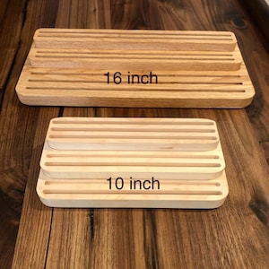 K&ouml;nnte beinhalten: Zwei Holzschneidebretter mit Rillen. Das gr&ouml;&szlig;ere Brett ist 16 Zoll lang und das kleinere 10 Zoll.