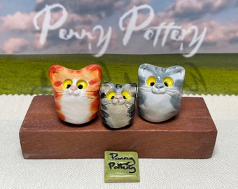 Miniature Ceramic Cat Families. 2 Cats and their Kitten. Designed and made by hand by collected UK artist Penny Howarth.