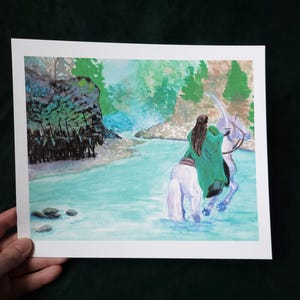 May include: A watercolor painting of a woman riding a white horse through a river. The woman is wearing a green cloak and has long brown hair. The horse is wading through the water, and there are trees and rocks in the background.