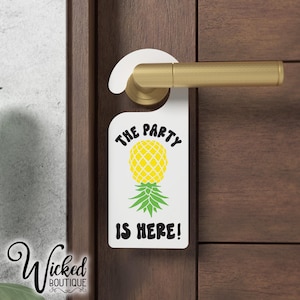May include: White door hanger with a pineapple graphic and the text "The Party Is Here!"