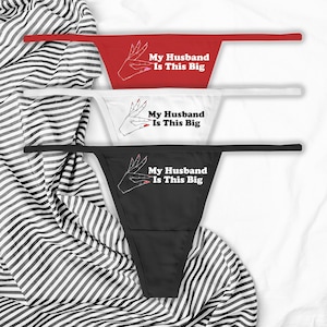 May include: Three pairs of black, white and red underwear with a graphic print of a hand and the text "My Husband Is This Big".