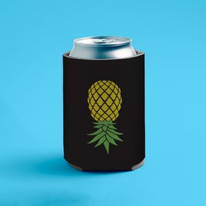 May include: Black neoprene can cooler with a yellow pineapple graphic. The pineapple has green leaves.