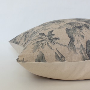 beige and gray floral pillow