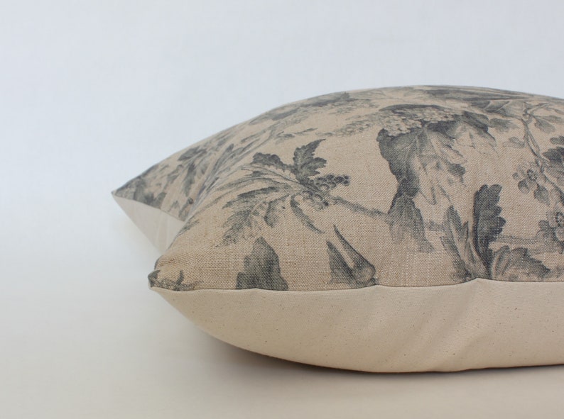 beige and gray floral pillow