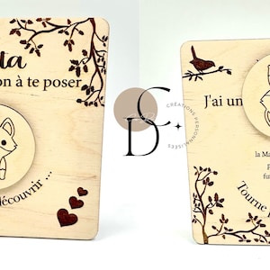 May include: A wooden sign with a spinning wheel that reveals a message. The sign is decorated with a fox, a bird, and hearts. The text on the sign reads "Jata, I have a question to ask you. Turn to find out..."