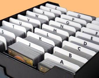 May include: A black card organizer with 26 compartments labeled with letters of the alphabet from A to Z. The compartments are filled with stacks of cards.