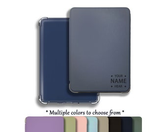 May include: A blue and gray e-reader case with a personalized name. The case has a clear back and a soft, textured front. The case is available in multiple colors, including purple, green, pink, blue, beige, black, navy, and green.