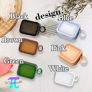 May include: A set of 6 clear phone cases with different colored accents. The cases are designed for Airpods and have a small loop for attaching a keychain. The colors are black, brown, green, blue, pink, and white.