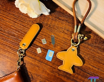 Portatarjetas SIM magnético de cuero con forma de pez avión personalizado, portaherramientas para expulsar tarjetas SIM, colgante con diseño de pequeña obra de arte.