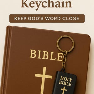May include: A brown leather-bound Bible with gold lettering and a gold cross. A black mini Bible keychain with gold lettering and a gold cross hangs from a gold keyring. The text reads "Mini Bible Keychain" and "Keep God's Word Close."