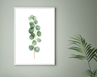 Pode incluir: Uma pintura de aquarela emoldurada de um único ramo de folhas de eucalipto sobre um fundo branco. A pintura está pendurada em uma parede verde claro acima de uma cama com almofadas verdes e brancas.