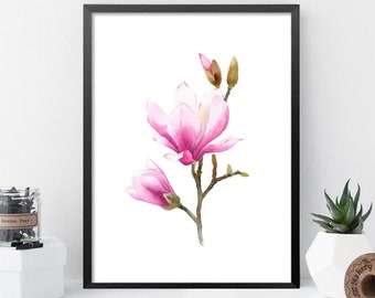 May include: A watercolor painting of a pink magnolia flower with green leaves and buds. The painting is framed in a black frame and is on a white background.