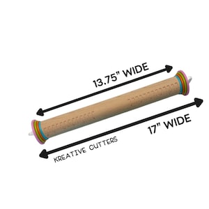 May include: A light-coloured wooden rolling pin with colourful rings at both ends and printed measurement markings along the barrel. The text 13.75" WIDE and 17" WIDE indicates dimensions, while the text KREATIVE CUTTERS is also visible.