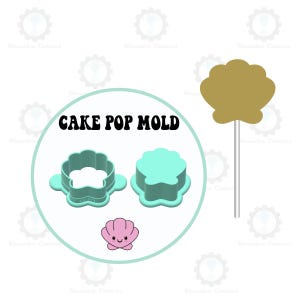 May include: A cake pop mould set with a seashell theme. The set includes a light blue seashell-shaped mould, a pink seashell graphic, and a gold seashell on a stick. The text "CAKE POP MOLD" is displayed.