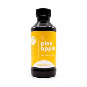 May include: A dark brown plastic bottle with a black screw-top cap and a yellow label. The label features a white pineapple icon, the text "pine apple", "NET WT. 4FL.OZ", "PKBAKES.com", and a circular logo with the letters "Pk" and "PORSHA".